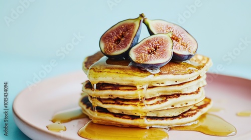   A pancake tower topped with figgy slices and syrupy goodness photo