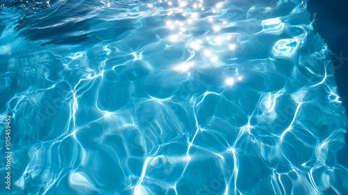 Abstract blue water surface with sunlight reflections.