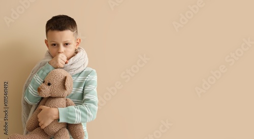 Ill little boy with toy bea...