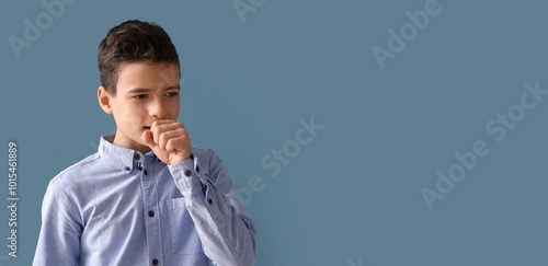 Coughing little boy on blue...