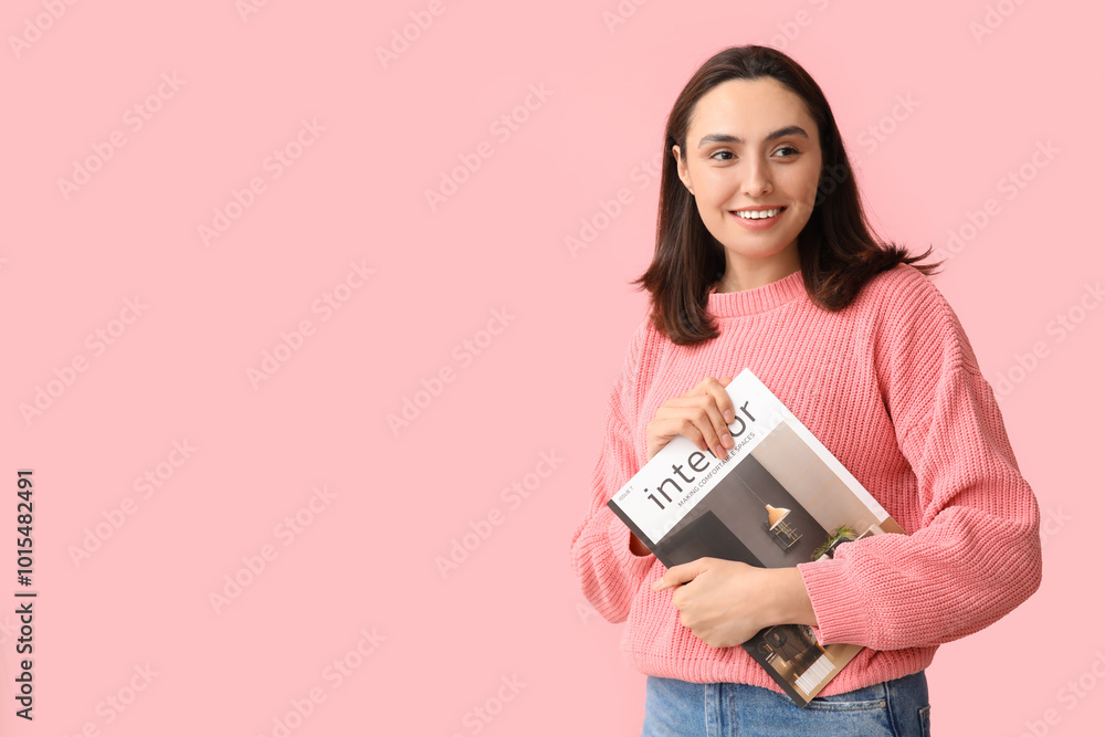 Beautiful young woman with interior magazine on pink background Beautiful young woman with interior magazine on pink background