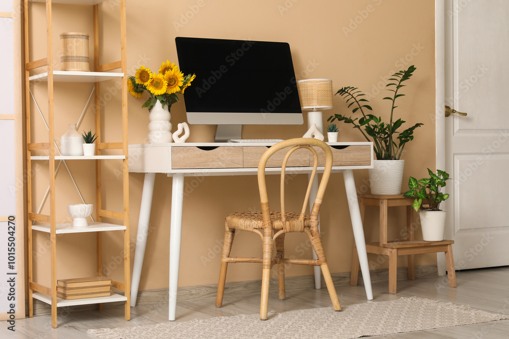 Fototapeta premium Interior of office with workplace, shelf unit and plants