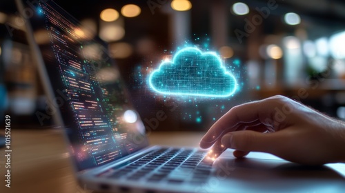 Close-up of hands working on a laptop with a luminous cloud hologram illustrating data security and digital innovation in a modern office setting