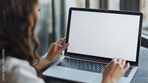 Woman interacting with laptop touchpad on minimalistic workspace for productivity technology remote work digital lifestyle and modern design concept