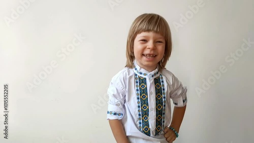 A little boy dressed in Ukrainian traditional clothes, vyshyvanka. Smiling child looking at the camera. Portrait of a little kid smiling child looking at the camera. Children's smile. Close-up face