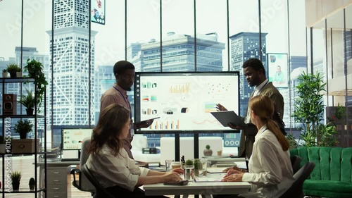 In a multinational company, advisory board meeting to discuss global strategies and work on finance planning. Managers ensuring the integration of development to drive profitability. Camera B.