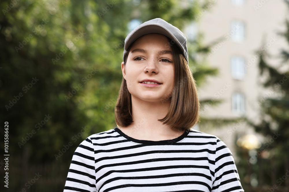 Portrait of smiling woman in baseball cap outdoors Portrait of smiling woman in baseball cap outdoors