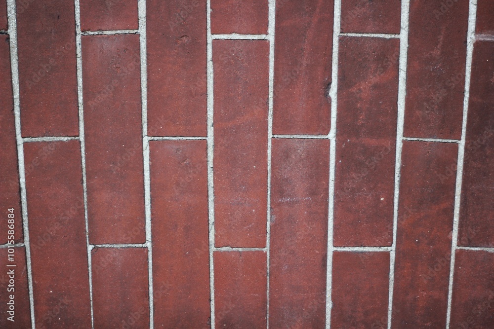 Fototapeta premium A red brick wall with white mortar.