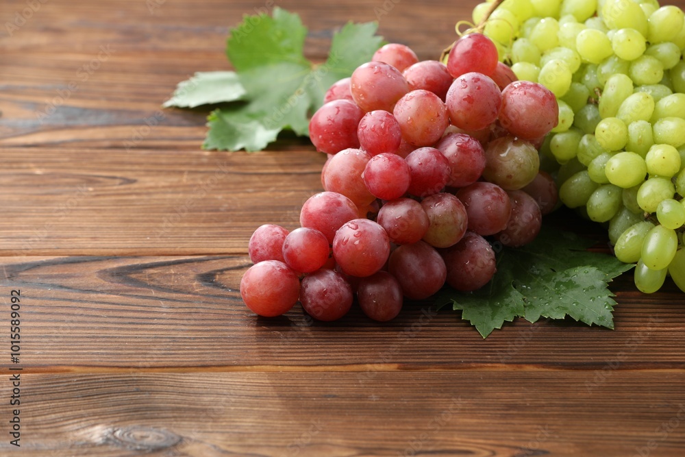 Fresh ripe grapes on wooden table, closeup. Space for text Fresh ripe grapes on wooden table, closeup. Space for text