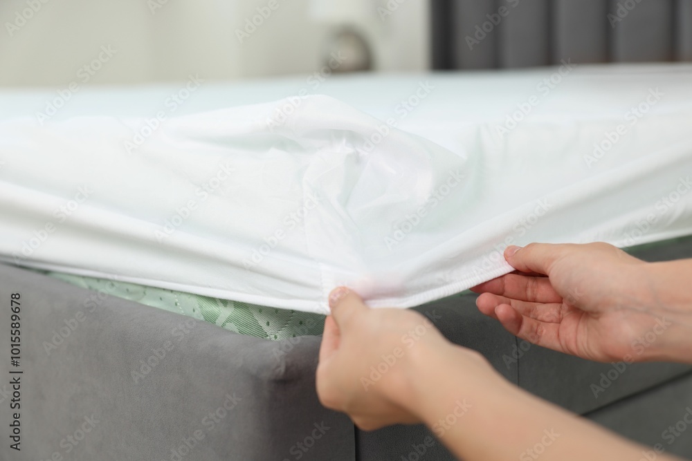 Woman changing clean bed linens at home, closeup Woman changing clean bed linens at home, closeup