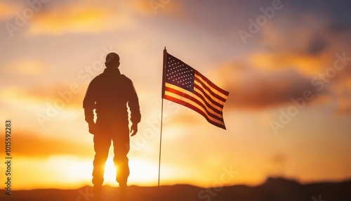 Silhouette of a soldier with an American flag at sunset.