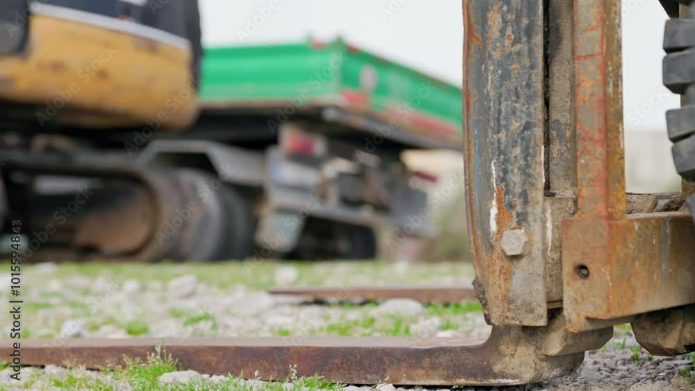 A cute dachshund wearing an orange safety vest and helmet sits at a construction site, adding humor and charm to a workday scene. A cute dachshund wearing an orange safety vest and helmet sits at a construction site, adding humor and charm to a workday scene.