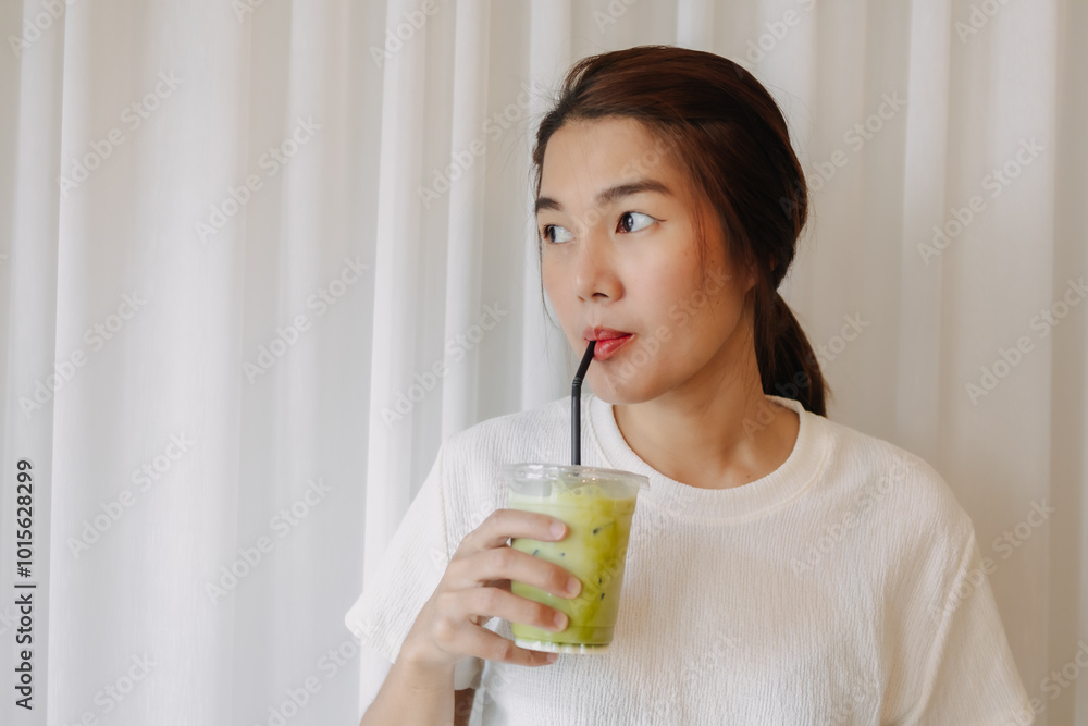 Happy healthy Asian woman drinking Iced Latte Matcha Green Tea. Happy healthy Asian woman drinking Iced Latte Matcha Green Tea.