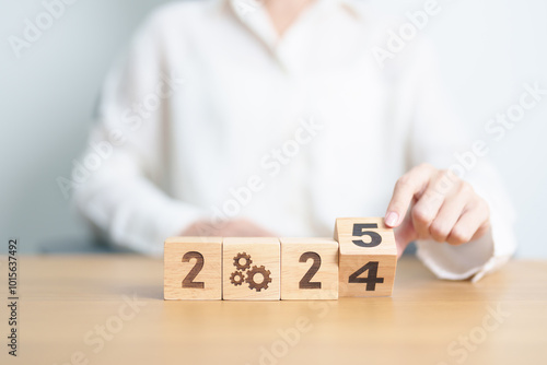 2024 year change to 2025 year block with gear icon. Business Process, Team, teamwork, Goal, Target, Resolution, strategy, plan, Action, motivation, change, brainstorm and New Year start concepts