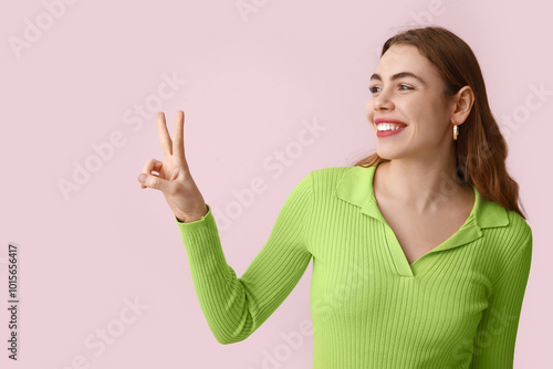 Pretty young woman showing ...