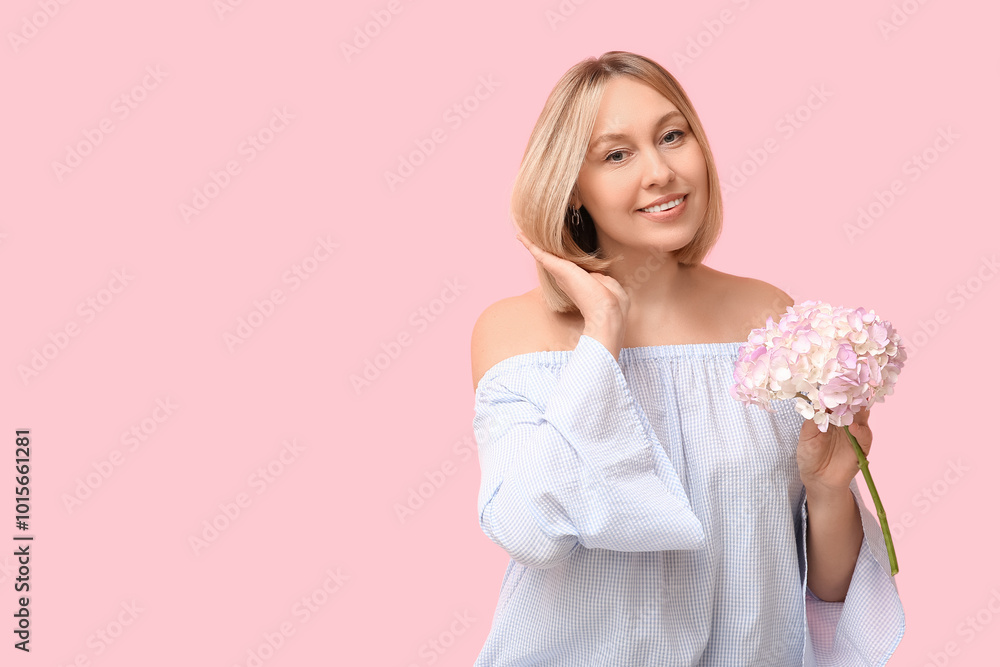 Beautiful young woman with bob hairstyle holding hydrangea flowers on pink background Beautiful young woman with bob hairstyle holding hydrangea flowers on pink background