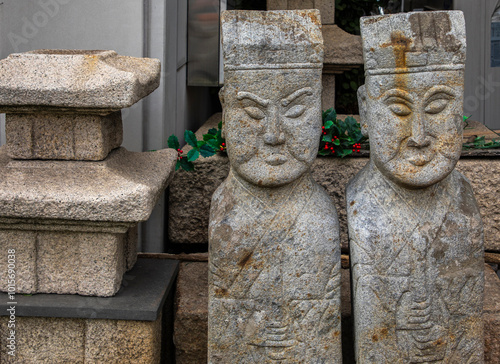 Stone jangseungs(Korean traditional totem pole) at Seochon, Jongno-gu, Seoul, Korea - March 9, 2019: Seochon refers to the area between Gyeongbokgung Palace and Inwangsan Mt in Seoul.  photo