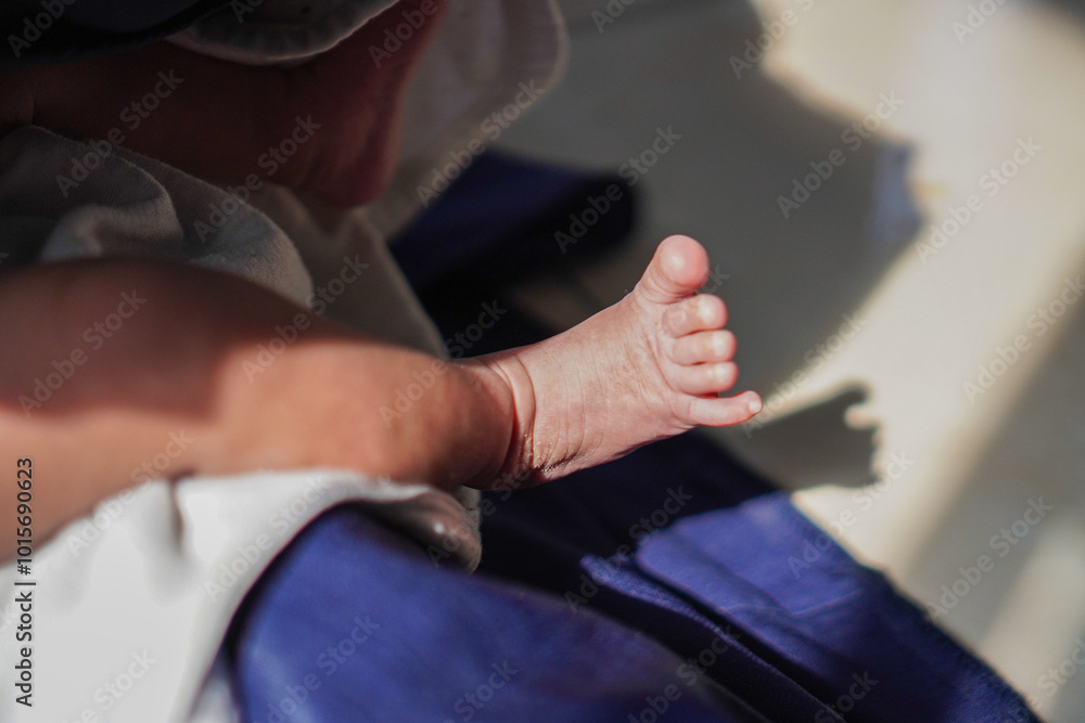 A close-up photo of a newborn baby's tiny foot. Tiny Baby Foot Background. Baby care Concept. A close-up photo of a newborn baby's tiny foot. Tiny Baby Foot Background. Baby care Concept.