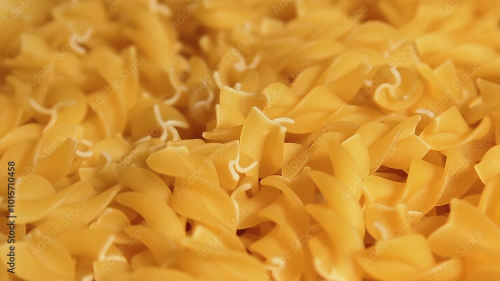 Uncooked Fusilli Pasta Rotating. Fat and Unhealthy Food. Dry Spiral Macaroni. Italian Culture and Cuisine. Raw Golden Pasta Uncooked Fusilli Pasta Rotating. Fat and Unhealthy Food. Dry Spiral Macaroni. Italian Culture and Cuisine. Raw Golden Pasta