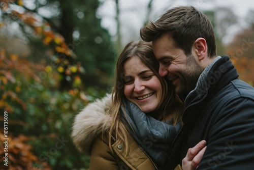 Young couple in love in the autumn park. A man and a woman hug each other.