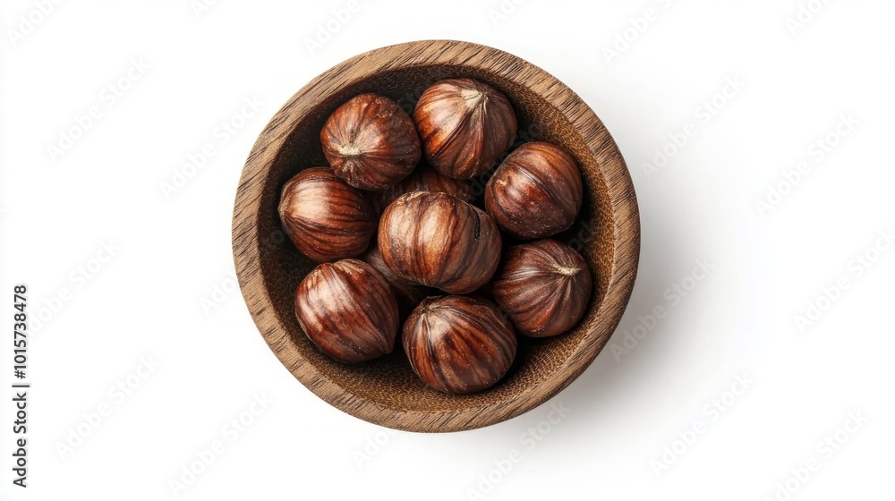 Obraz premium A wooden bowl filled with whole hazelnuts, shot from above on a white background.