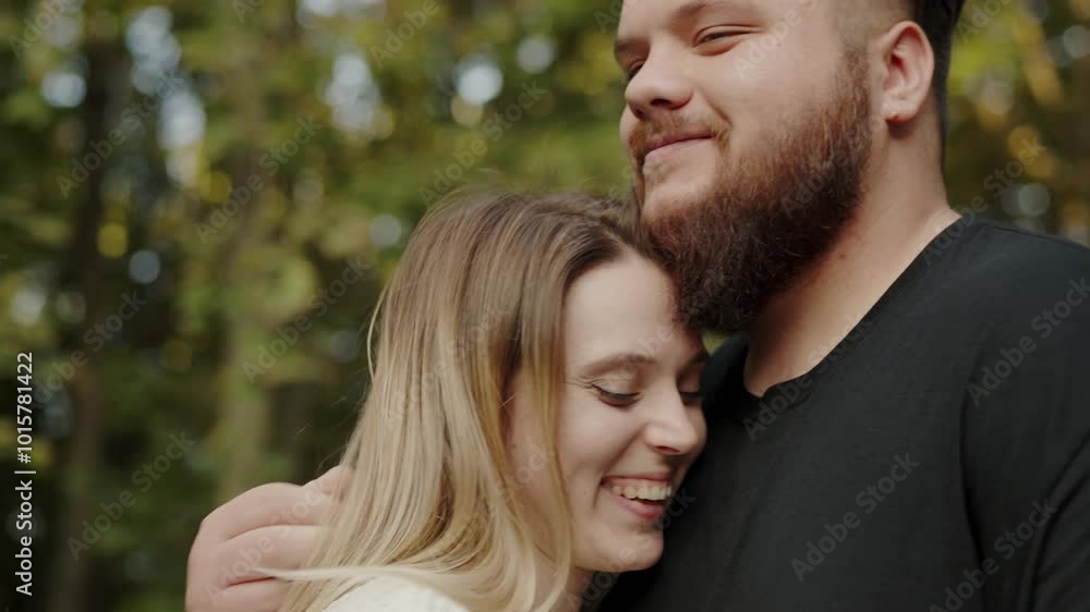 Close-up of a young, affectionate couple embracing and smiling in a lush, outdoor setting. The image captures a serene and loving moment. Young Couple Sharing a Joyful Moment Together Outdoors Close-up of a young, affectionate couple embracing and smiling in a lush, outdoor setting. The image captures a serene and loving moment. Young Couple Sharing a Joyful Moment Together Outdoors