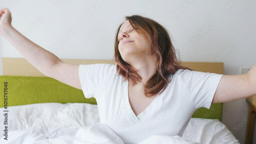 Young woman girl stretching in her bed in the morning. Close up. Young woman girl stretching in her bed in the morning. Close up.