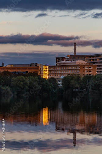 Stockholm, Sweden A building in the Liljeholmen district is reflected in the Trekanten Lake at sunet.