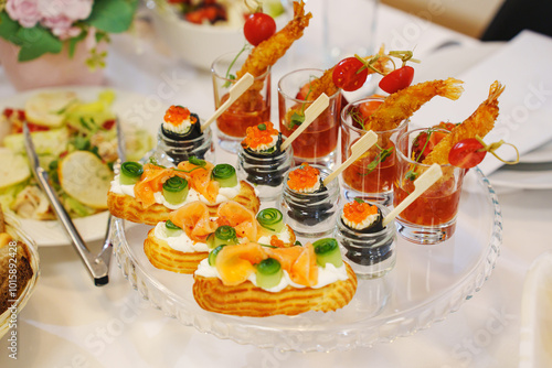 A served festive table with a variety of appetizers. catering for a banquet. sandwiches and canapes photo