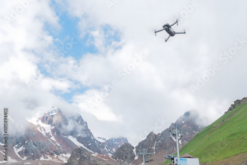 A photo of a quadcopter on snowy mountains