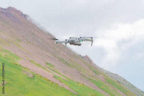A photo of a quadcopter on snowy mountains