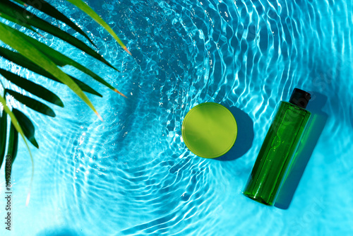 Bild auf Leinwand Green bottle floating on a clear blue swimming pool during bright daylight