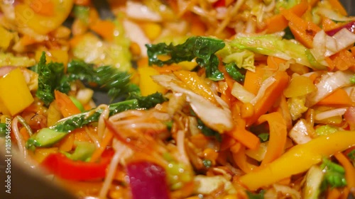 Close Up of Various Stir Fry Healthy Vegetables Being Cooked in Hot Wok Pan with Peppers, Onions, Cabbage, Carrots. Slow Motion Clip 4K photo