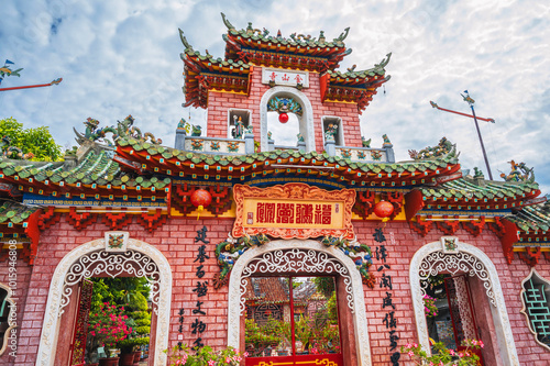 ancient red Asian gate to the Hoi Quan Phu Kien Buddhist pagoda in the old town in Hoi An in Vietnam in Asia photo