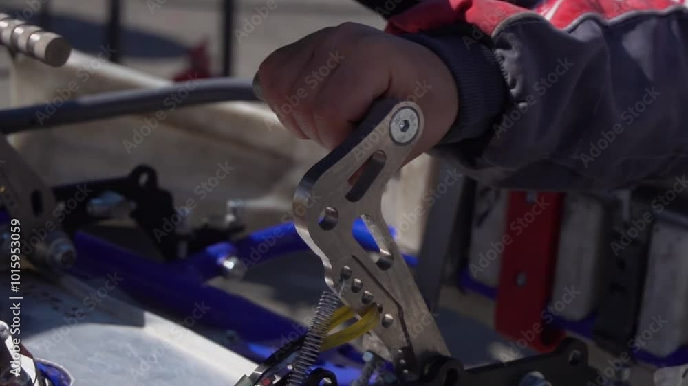 The driver warms up the engine and prepares the car for the competition. Karting driver warms up the engine by pressing the gas pedal The driver warms up the engine and prepares the car for the competition. Karting driver warms up the engine by pressing the gas pedal