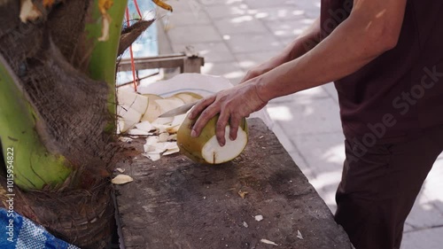 Man Breaking Fresh Coconut First Time