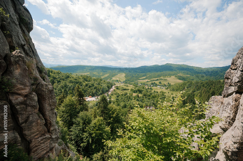 Serene Mountain Landscape with Lush Green Valleys Under a Blue Sky