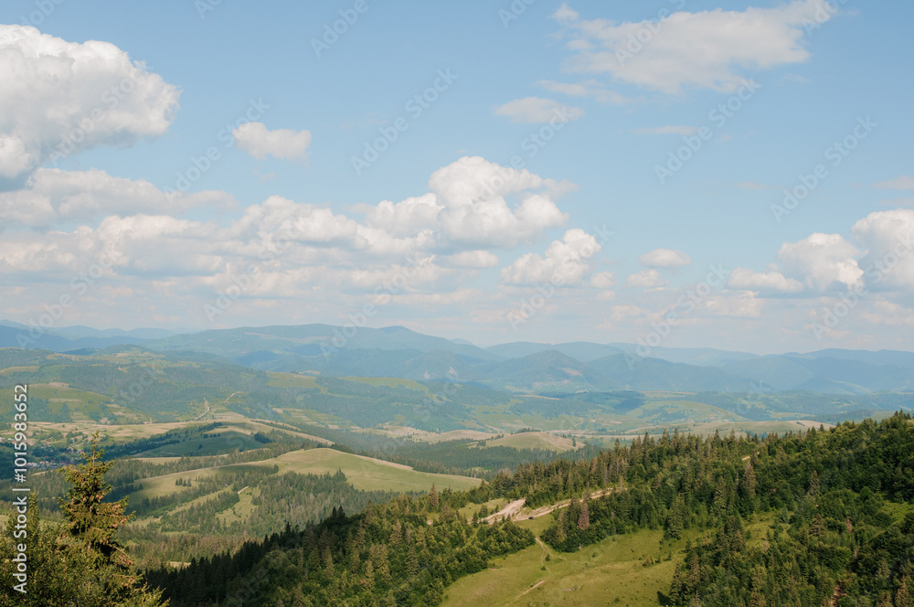 Serene Mountain Landscape Under a Blue Sky with Fluffy Clouds Serene Mountain Landscape Under a Blue Sky with Fluffy Clouds