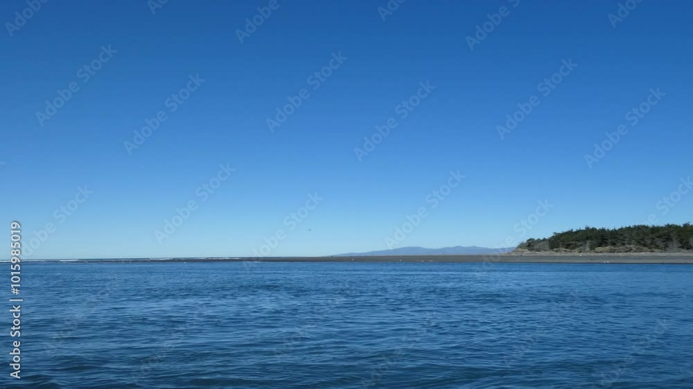 Incoming waves from ocean mix with inky blue river water on a beautiful mid-winter's day (Kairaki Beach and Waimakariri River, New Zealand) Incoming waves from ocean mix with inky blue river water on a beautiful mid-winter's day (Kairaki Beach and Waimakariri River, New Zealand)