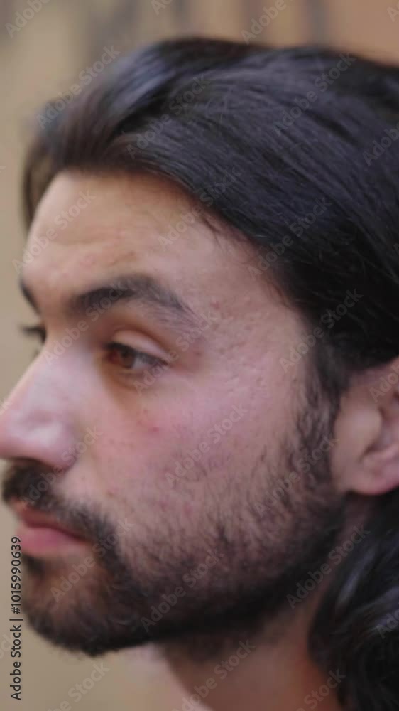 Vertical: A young man turns towards the camera with an extremely sad and puzzled expression. His eyes reflect deep sorrow and confusion. Vertical: A young man turns towards the camera with an extremely sad and puzzled expression. His eyes reflect deep sorrow and confusion.