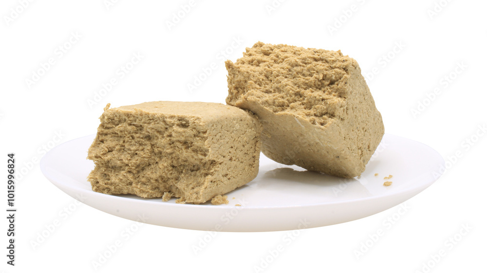 Sunflower halva in a white plate. Side view. Broken halvah pieces. Food isolated on transparent background. Isolate on png format Sunflower halva in a white plate. Side view. Broken halvah pieces. Food isolated on transparent background. Isolate on png format