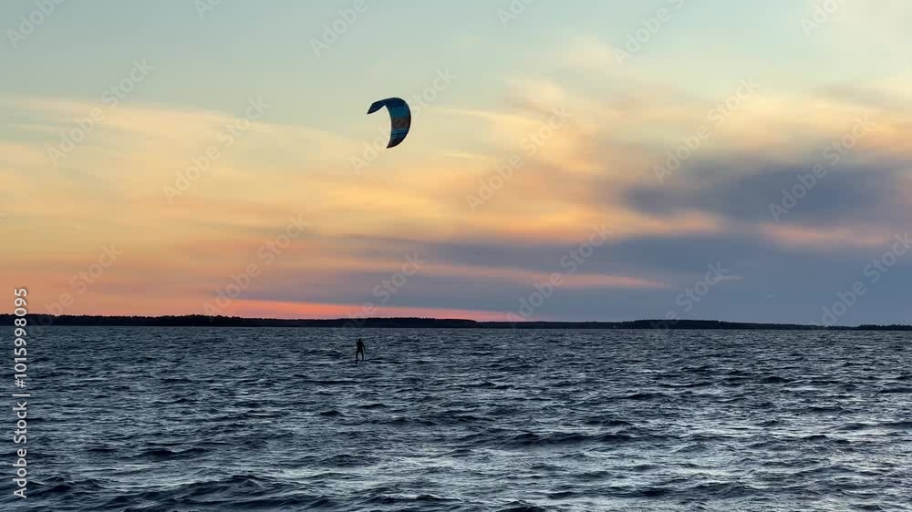 Kiteboarding on windy sea at sunset, Oulu Finland Kiteboarding on windy sea at sunset, Oulu Finland