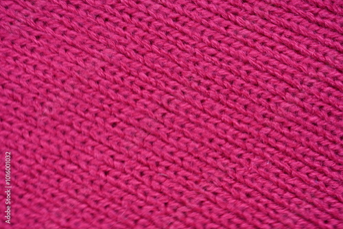 pink texture of knitted wool fabric as a background, smooth symmetrical lines of hand-knitted needlework pattern photo