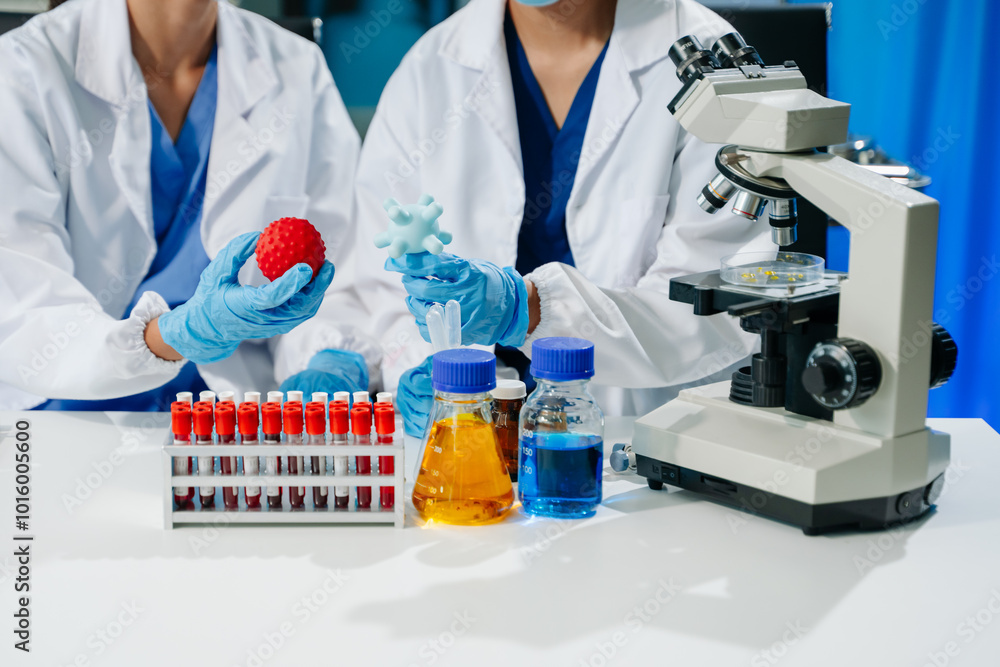 Fototapeta premium scientists in lab coats conducting research, handling glassware, and working with chemicals