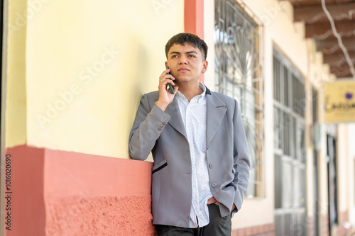 Young man talking on mobile phone on the street