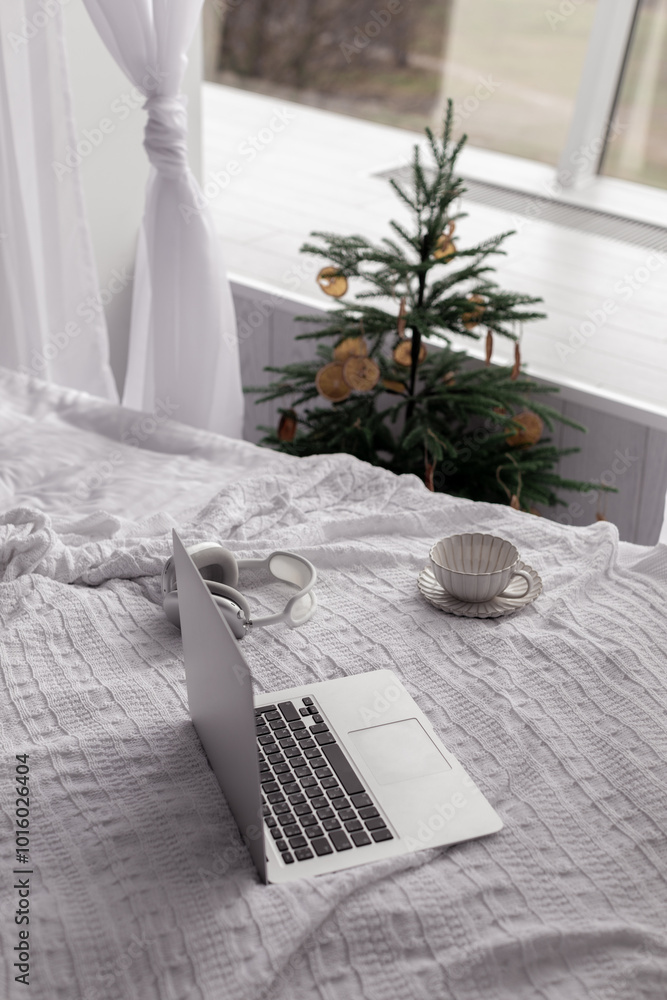 laptop in a home festive New Year's interior in a minimalist style - Image laptop in a home festive New Year's interior in a minimalist style - Image