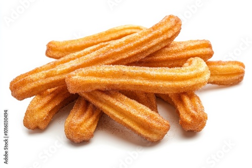 Golden brown churros coated in cinnamon sugar lie stacked on a clean white surface, capturing the essence of this delicious Spanish treat ready for any time enjoyment.