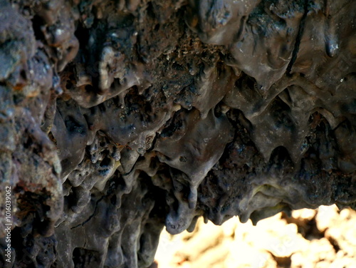 Chocolate like lava flows rock on Dolomieu crater, Fournaise volcano, Reunion island. Smooth surface of pahoehoe lava forming drop shaped rocks photo