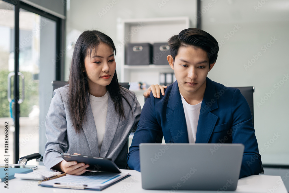Businessman team working are under stress from financial data and report graph. Businessman team working are under stress from financial data and report graph.