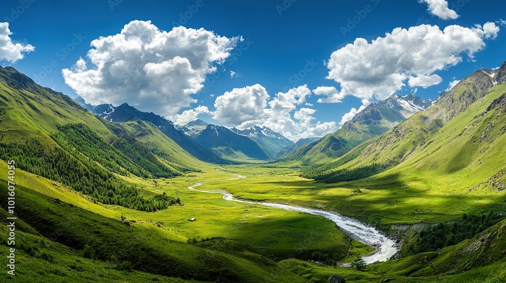 Fototapeta premium Wide angle shot of beautiful green mountain valley with white clouds in blue sky